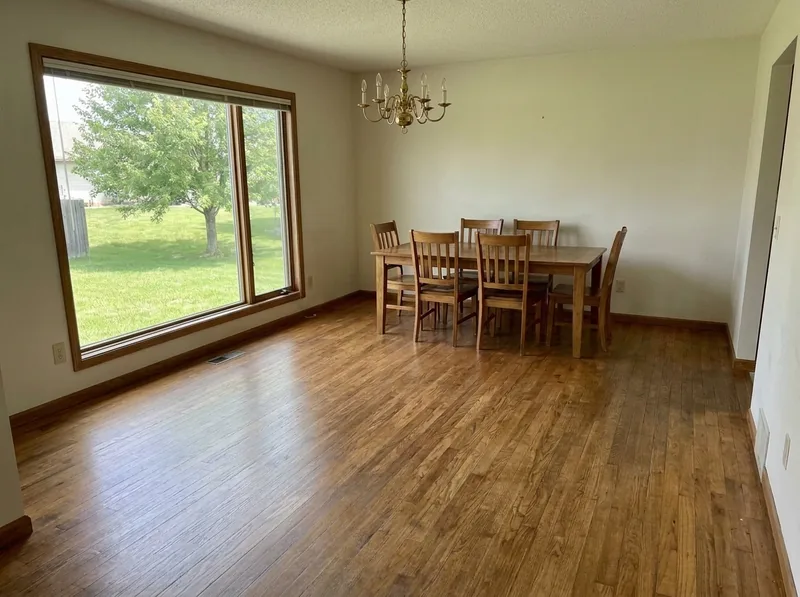 The same dining room oak floor after sanding and an even medium-brown stain