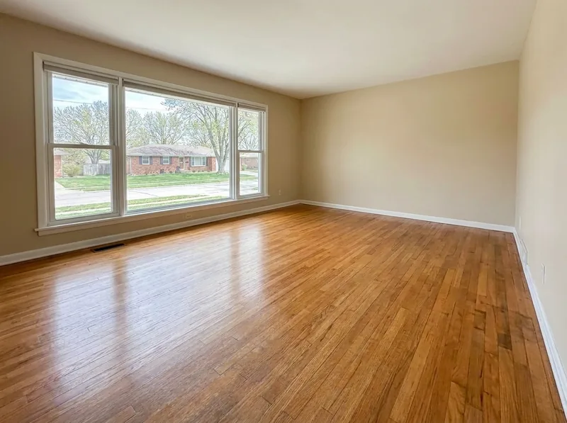 The same living room red oak floor after sanding and a natural satin finish