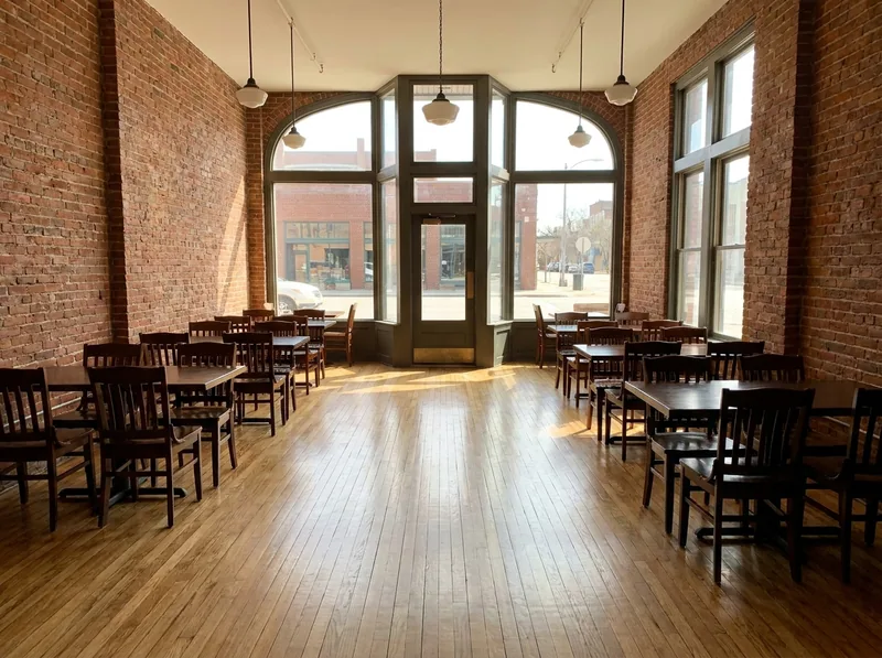 Refinished oak strip floor in a small restaurant with exposed brick walls